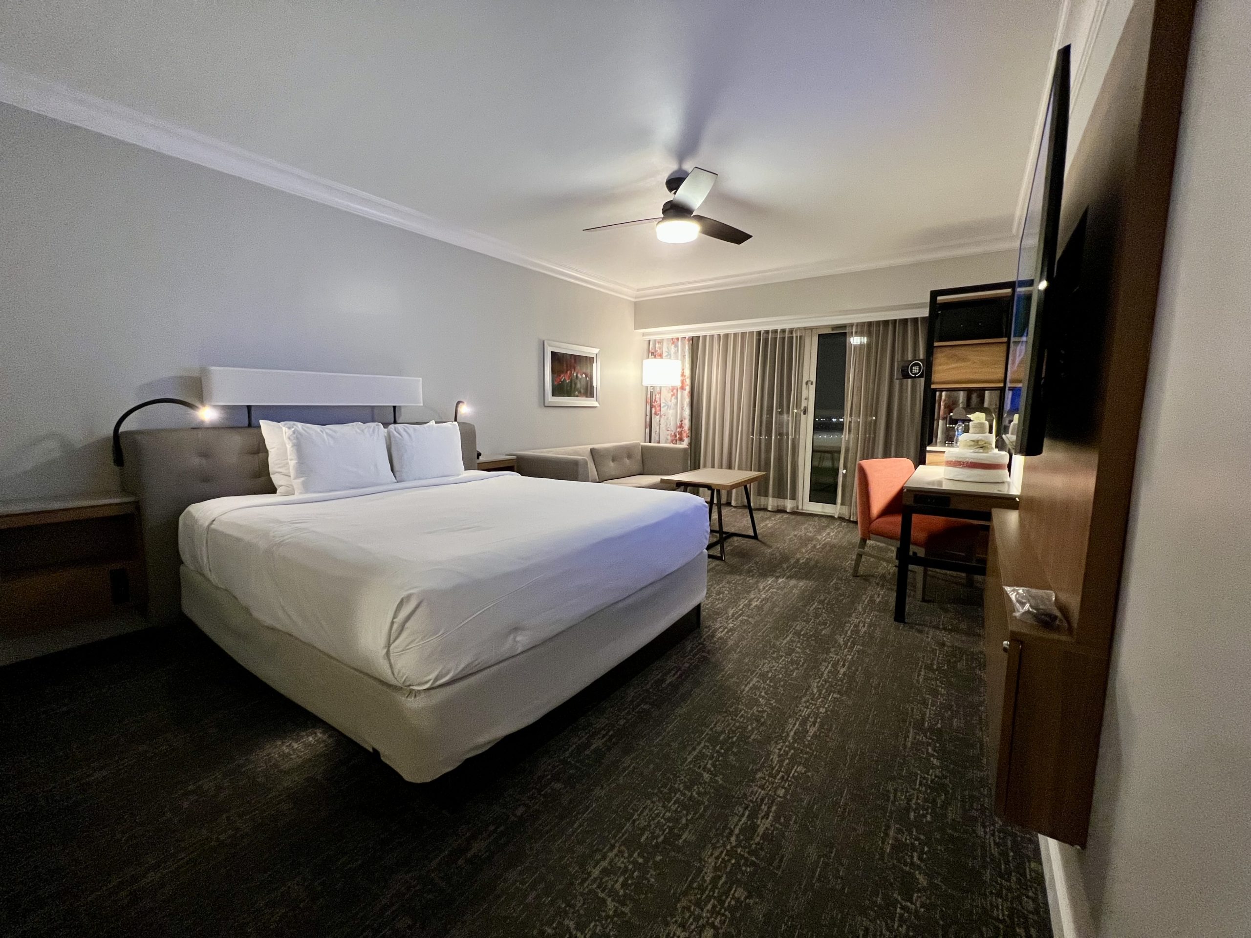 Modern hotel room with balcony and king bed