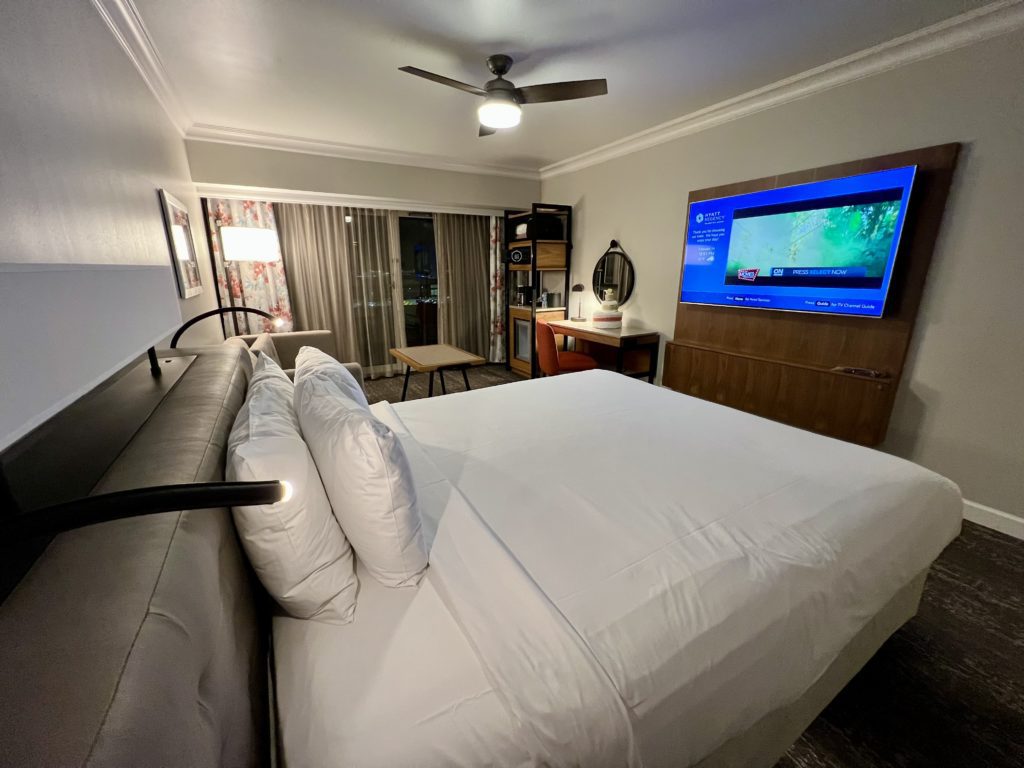 a bed with a television in the background