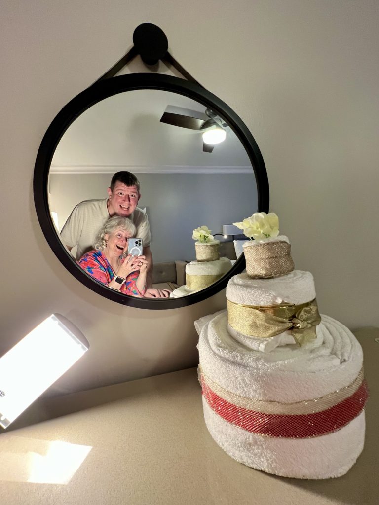 a man and woman taking a selfie in a mirror