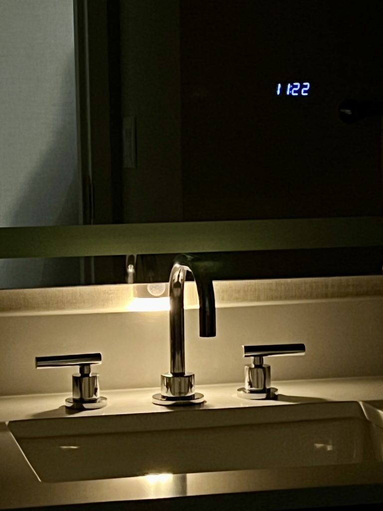 a sink with a mirror and faucet