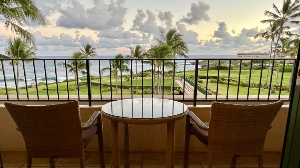 a table and chairs on a balcony overlooking a golf course