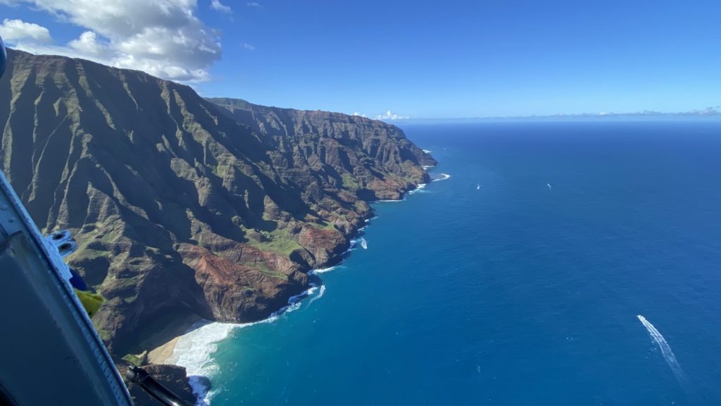 a large body of water next to a rocky cliff