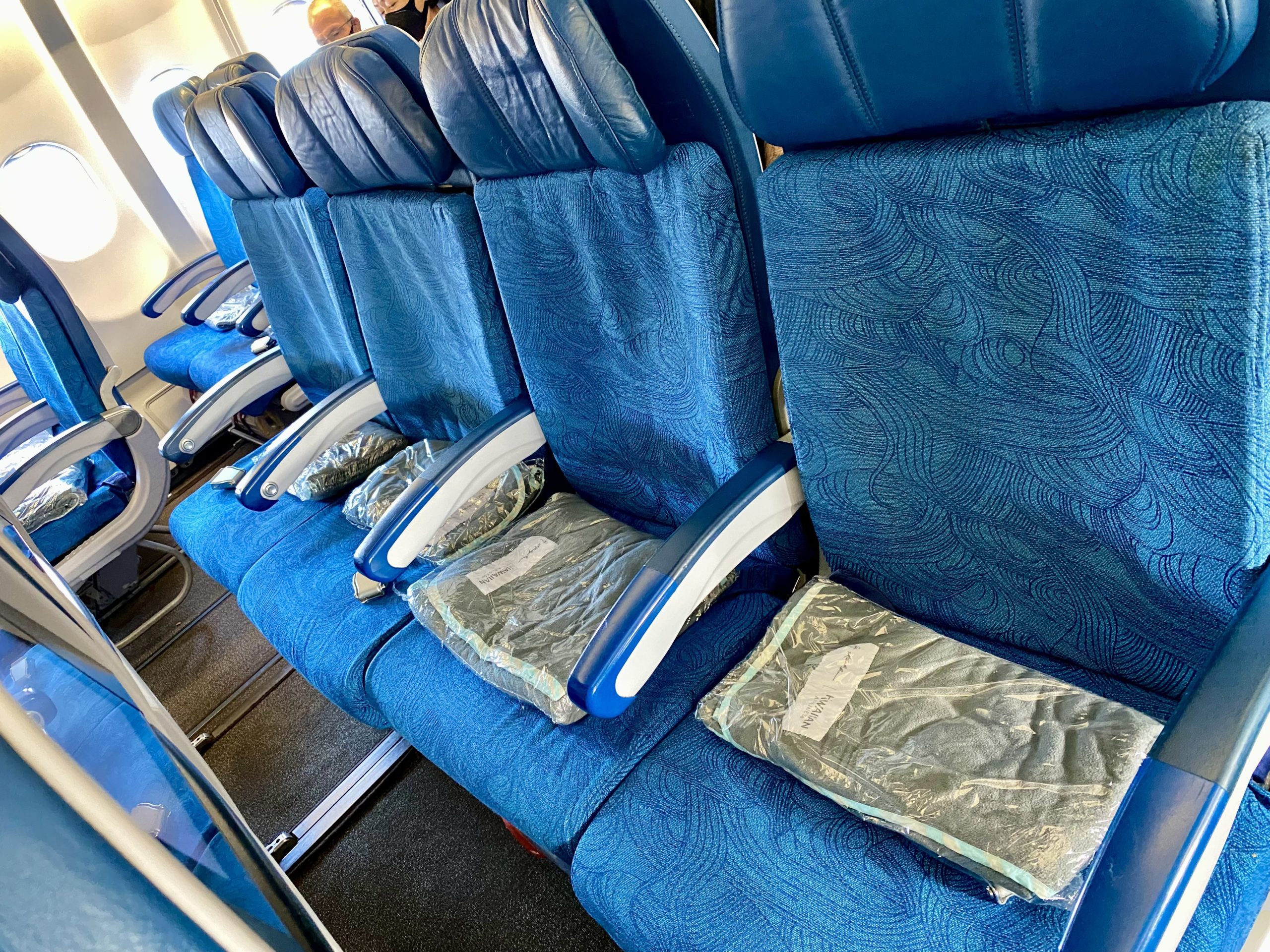 a row of blue seats with blue covers