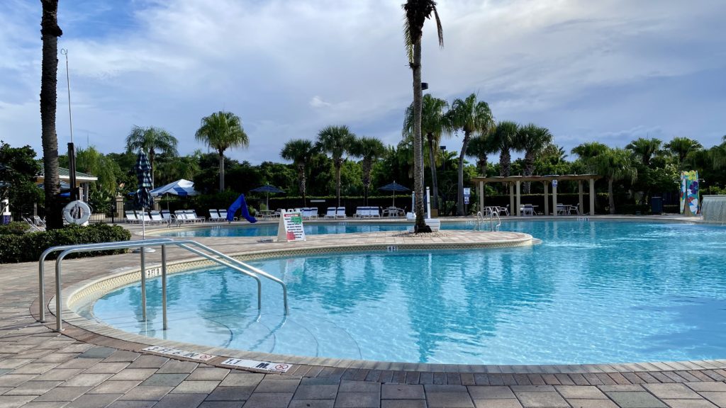 a pool with chairs and umbrellas