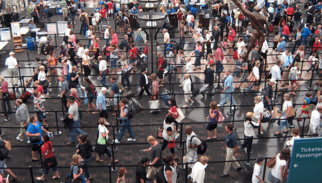 a crowd of people walking in a mall