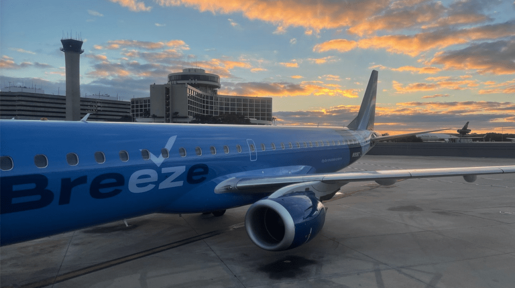 a blue airplane on a runway