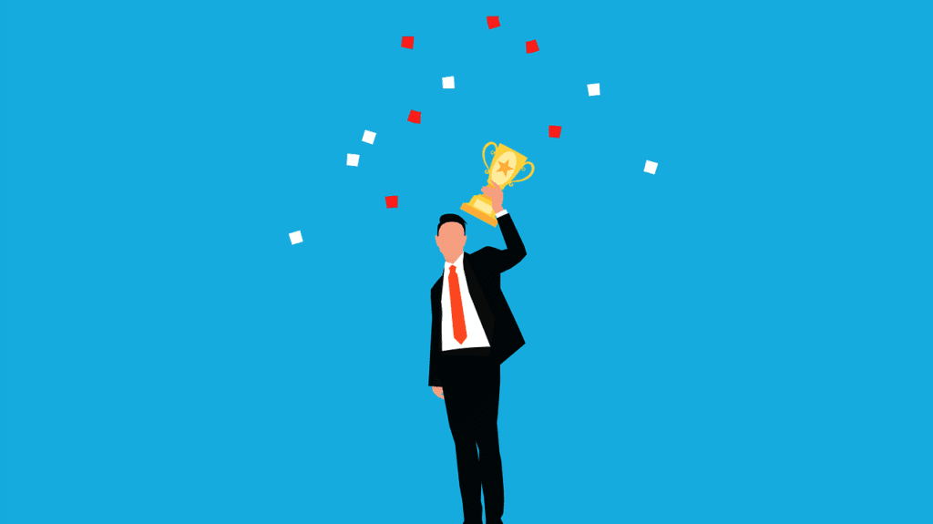 a man holding up a trophy