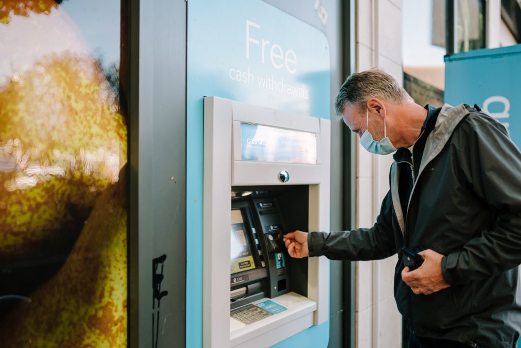 a man wearing a mask using a machine