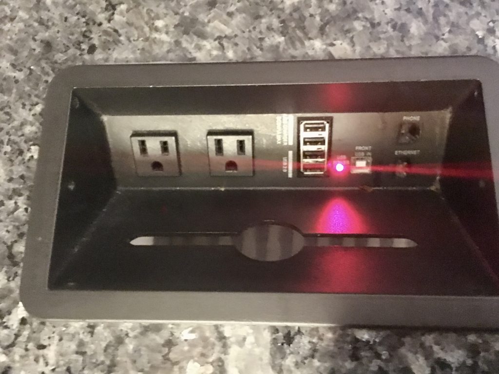 a rectangular black device with a red light