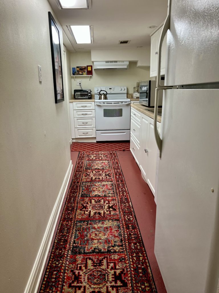 a kitchen with a rug on the floor