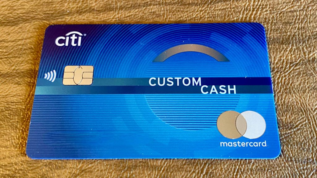 a blue credit card on a leather surface