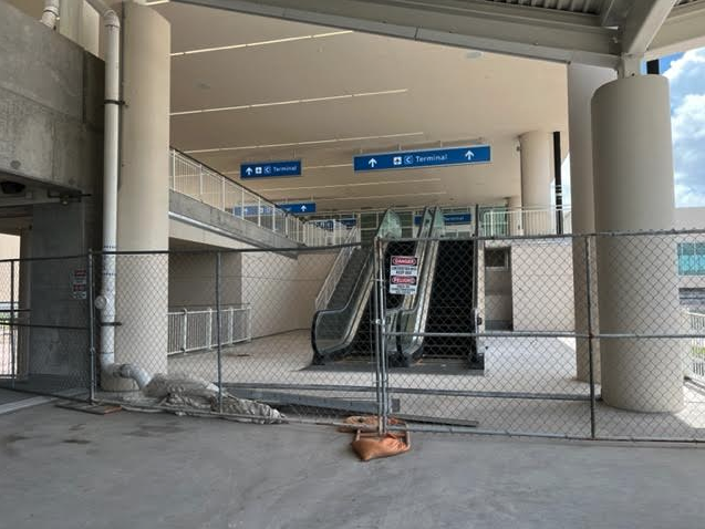 a fenced in area with escalators