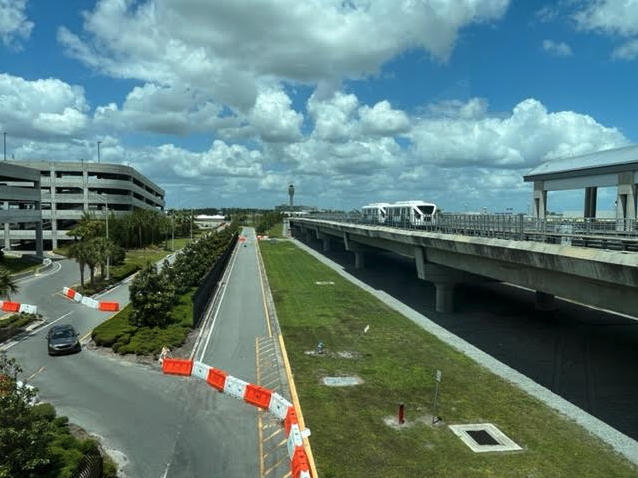 a road with a bridge and a bus on it