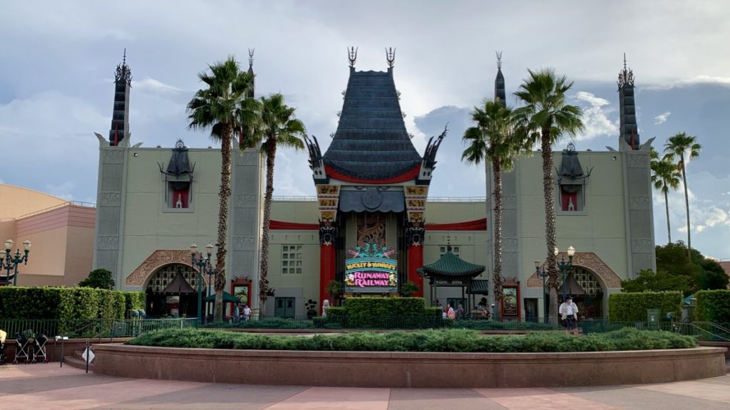 a building with palm trees and a sign