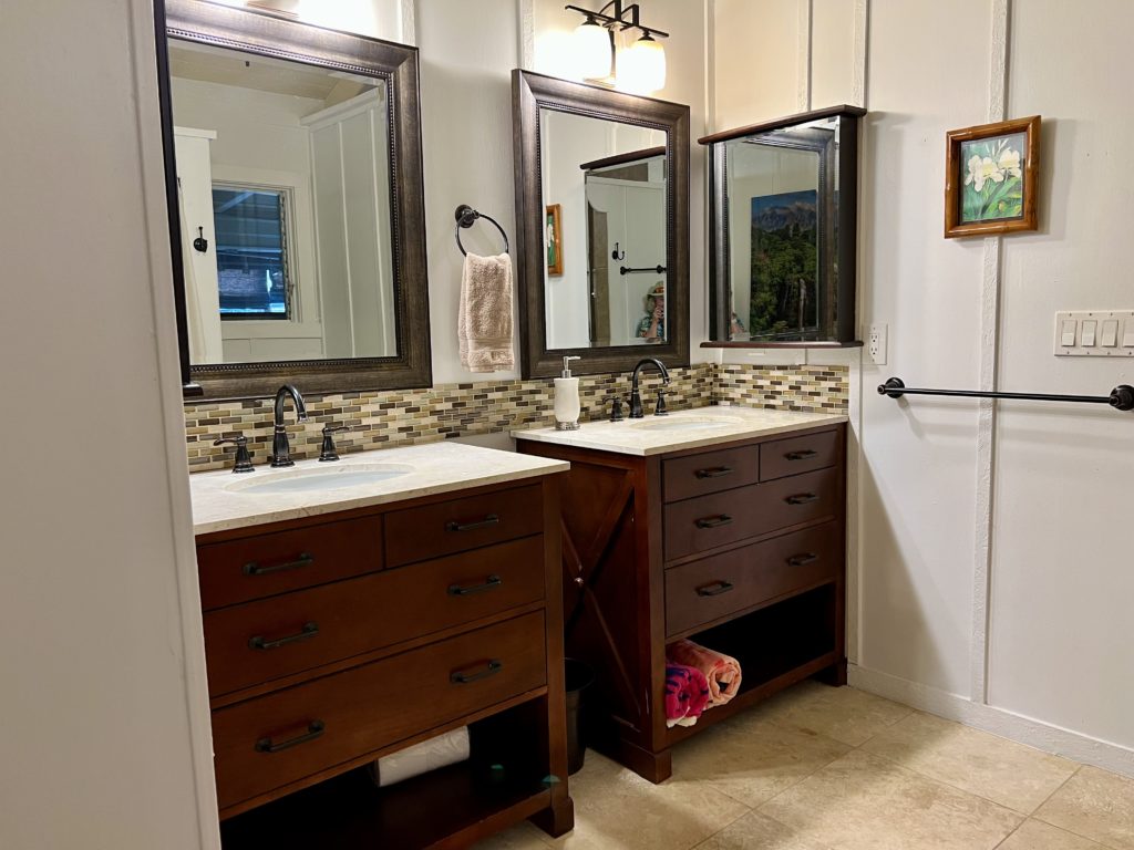 a bathroom with double sinks and mirrors