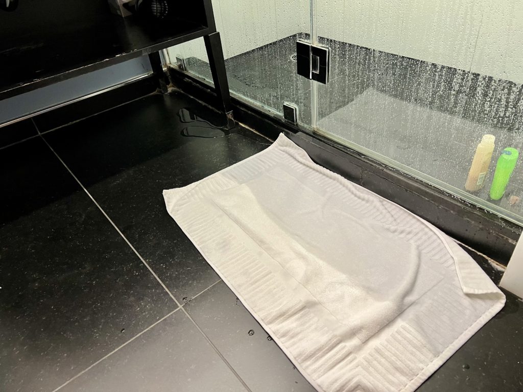 a white towel on a black floor
