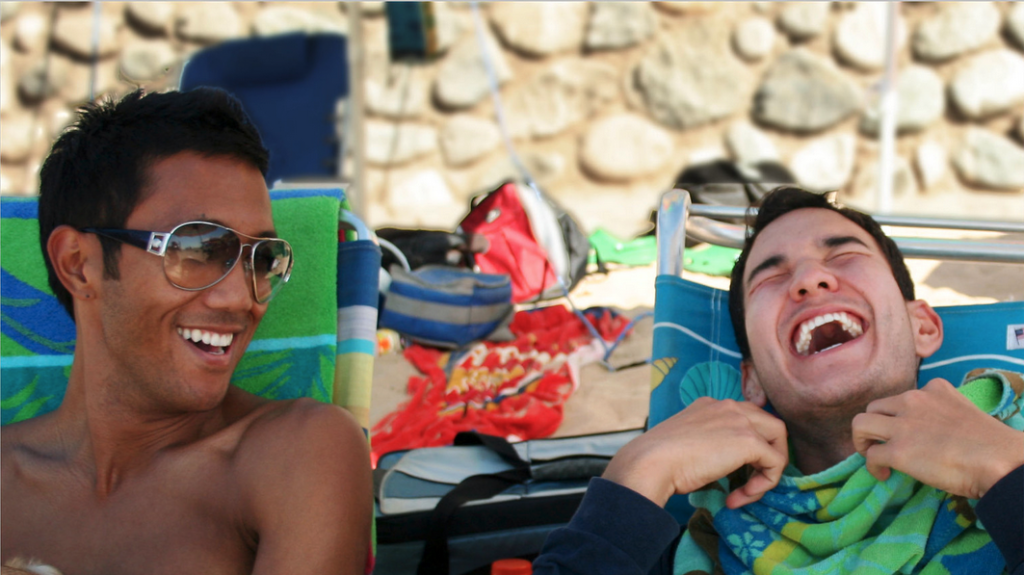 two men sitting in chairs laughing