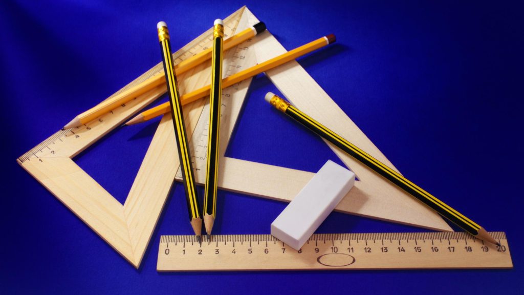 a group of pencils and ruler