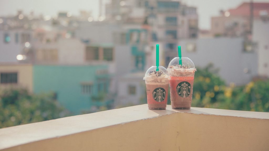 two cups of coffee on a ledge