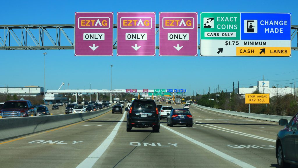 a highway with signs and cars on it