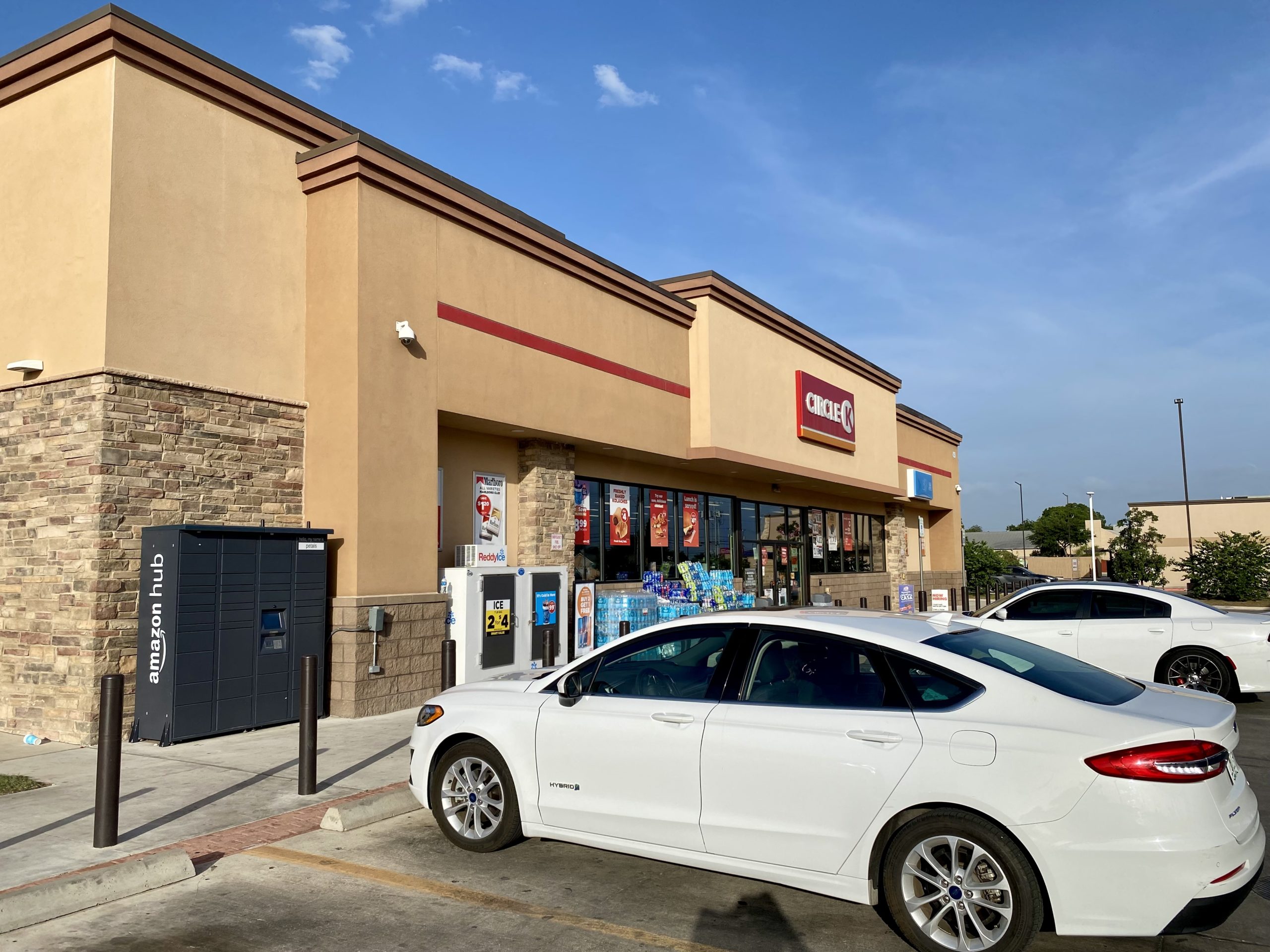 a white car parked in front of a store