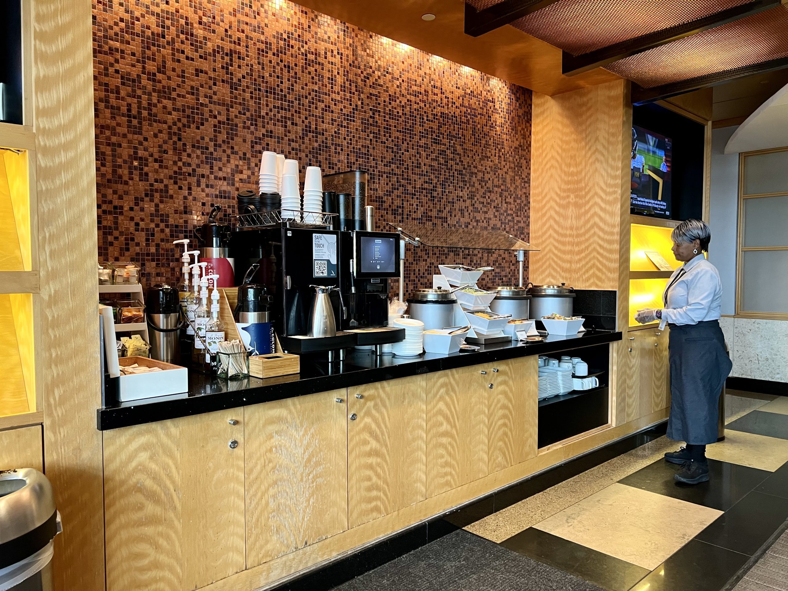 a woman standing in front of a buffet