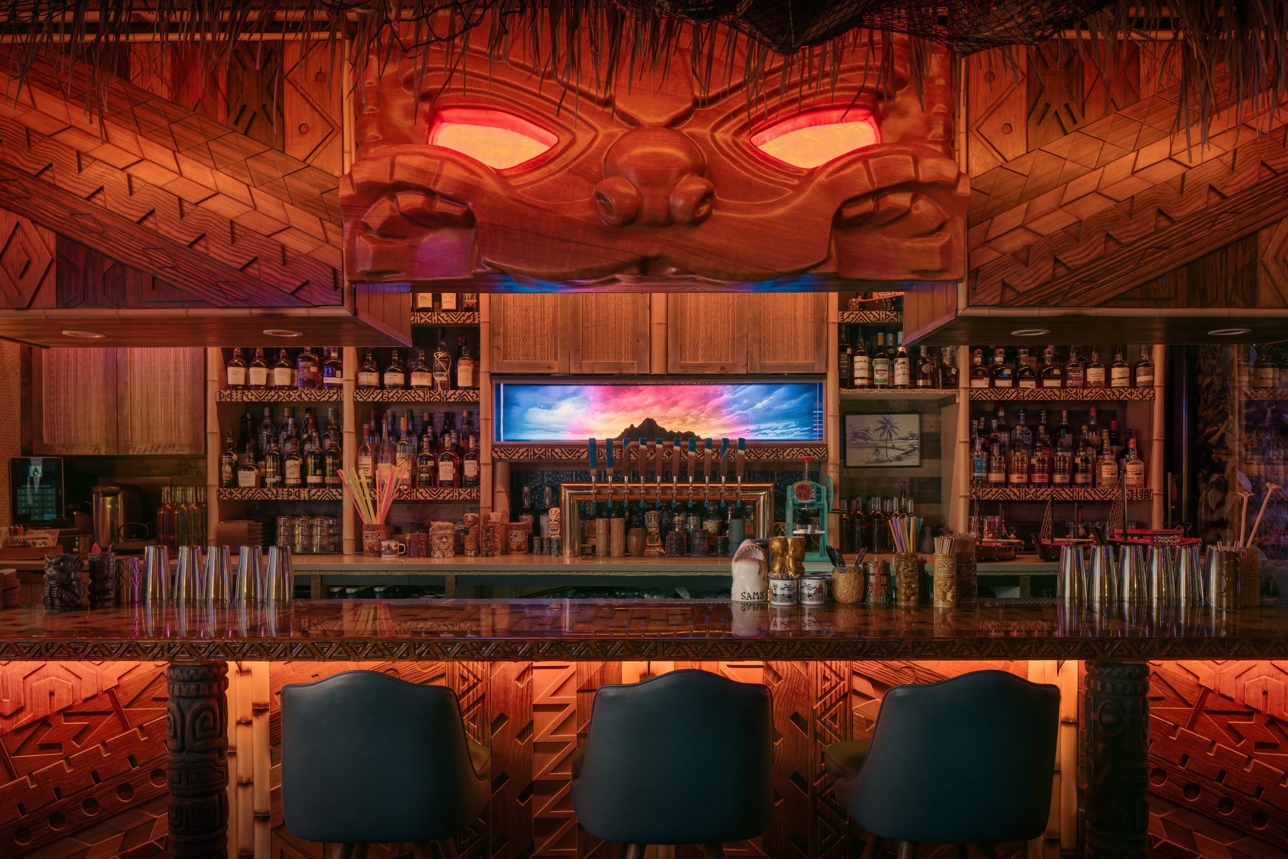 a bar with a wooden bar and chairs