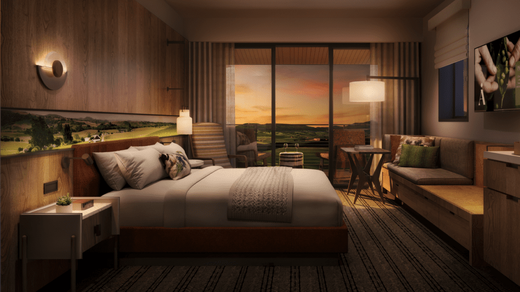 a bedroom with a view of a field and a sunset