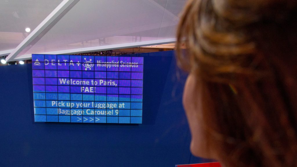 a woman looking at a sign