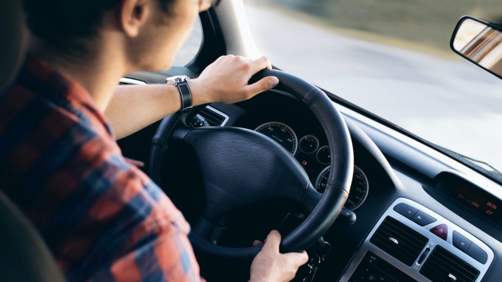 a man holding a steering wheel