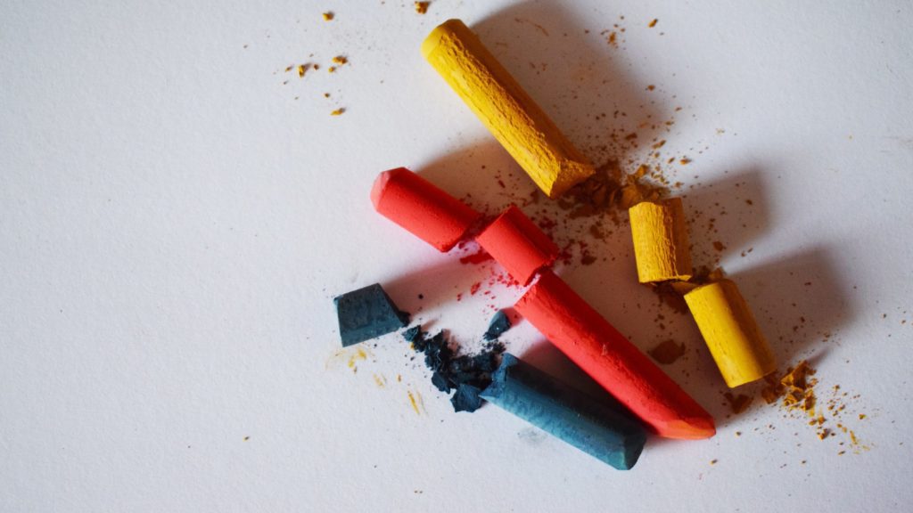 a group of crayons on a white surface