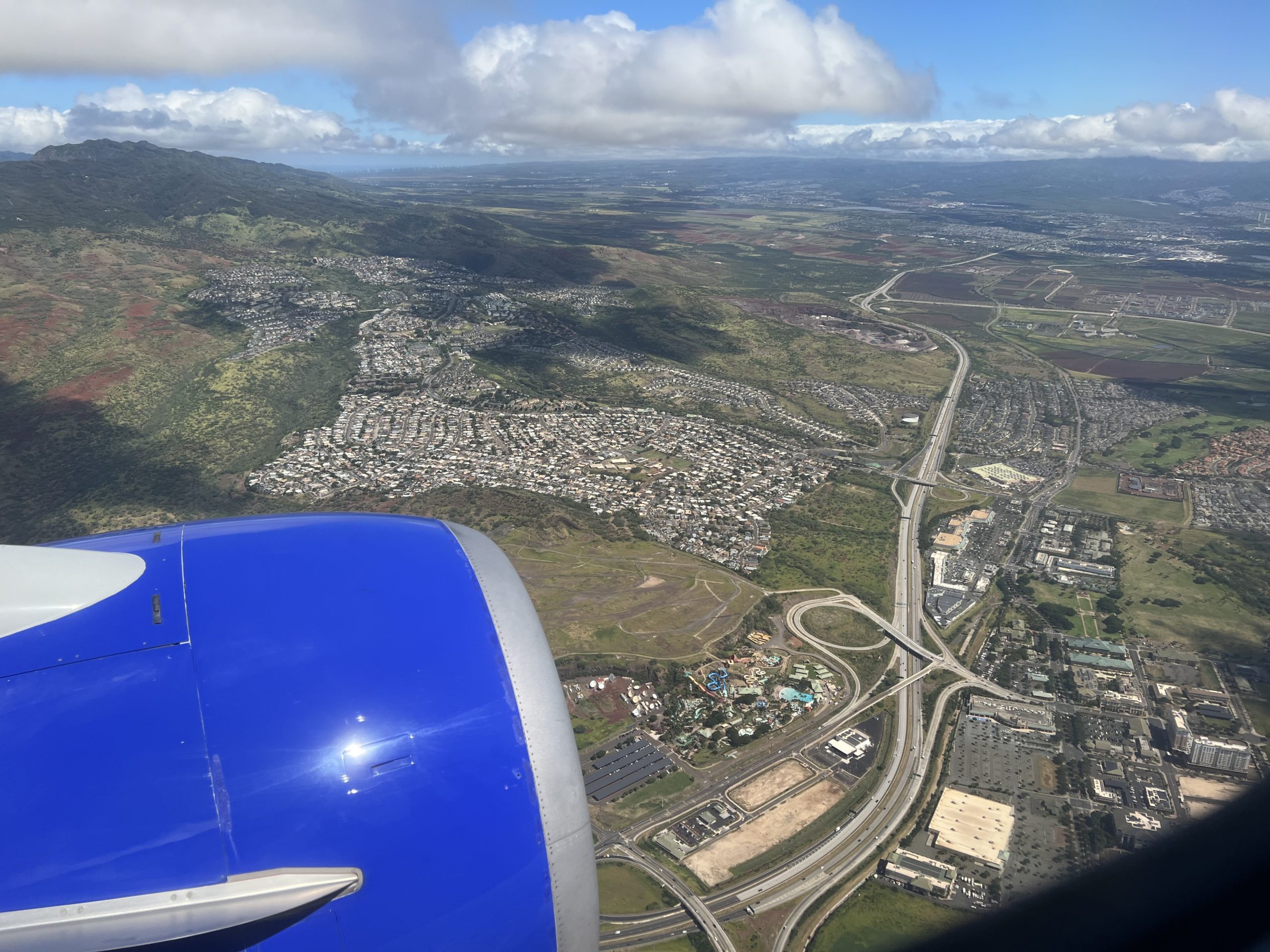 an airplane wing and a city