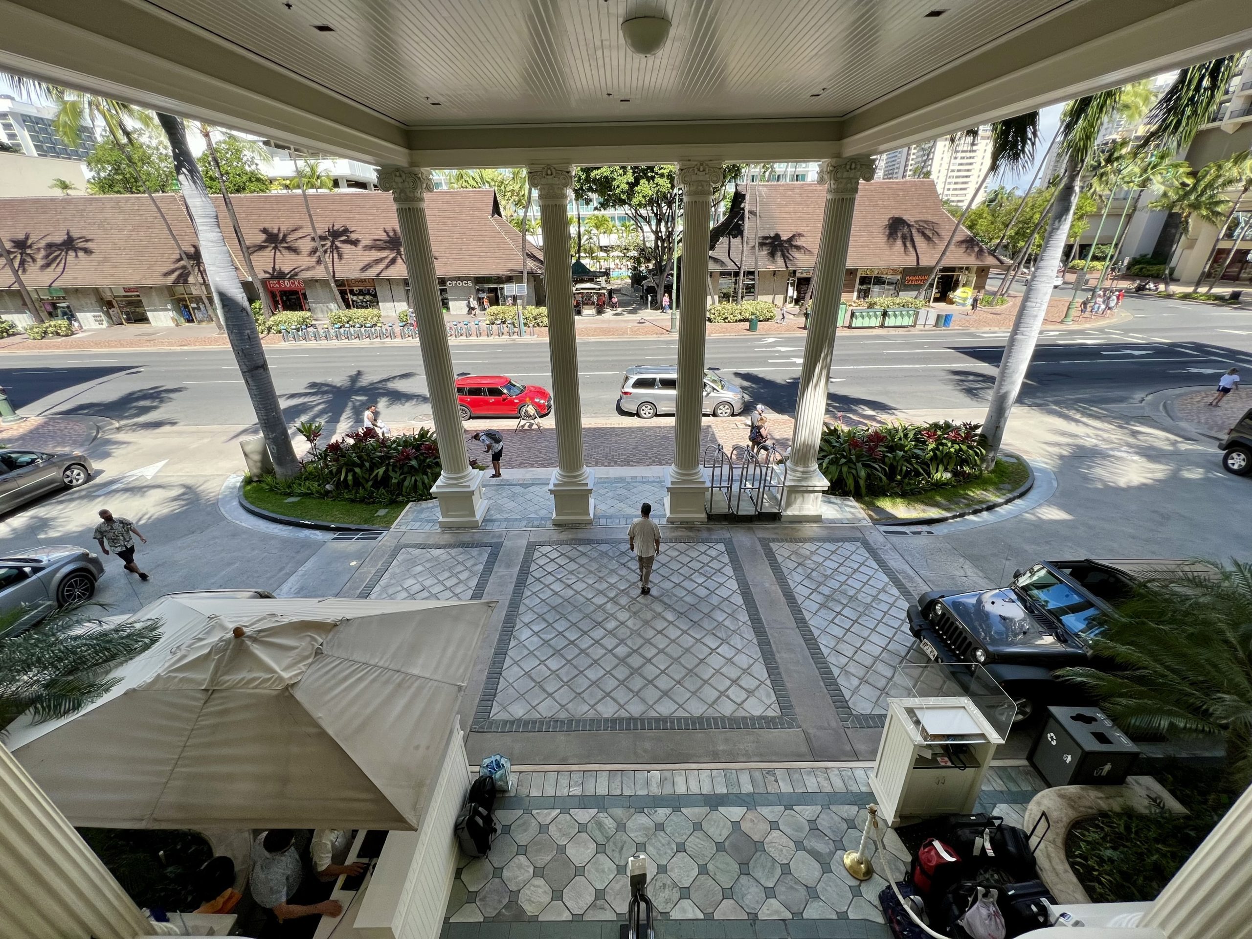 a person standing in a courtyard with columns