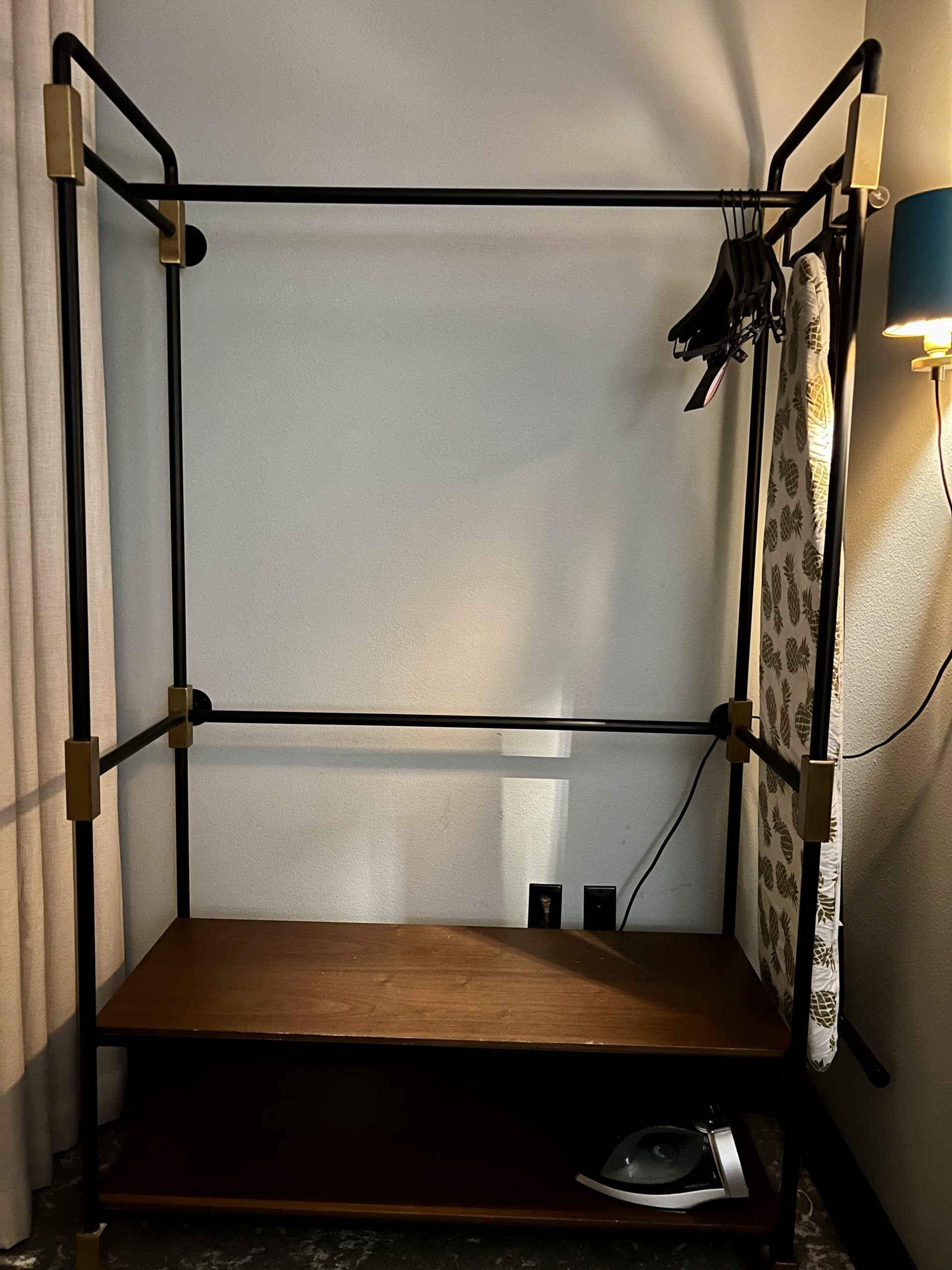 a clothes rack with a blue lamp