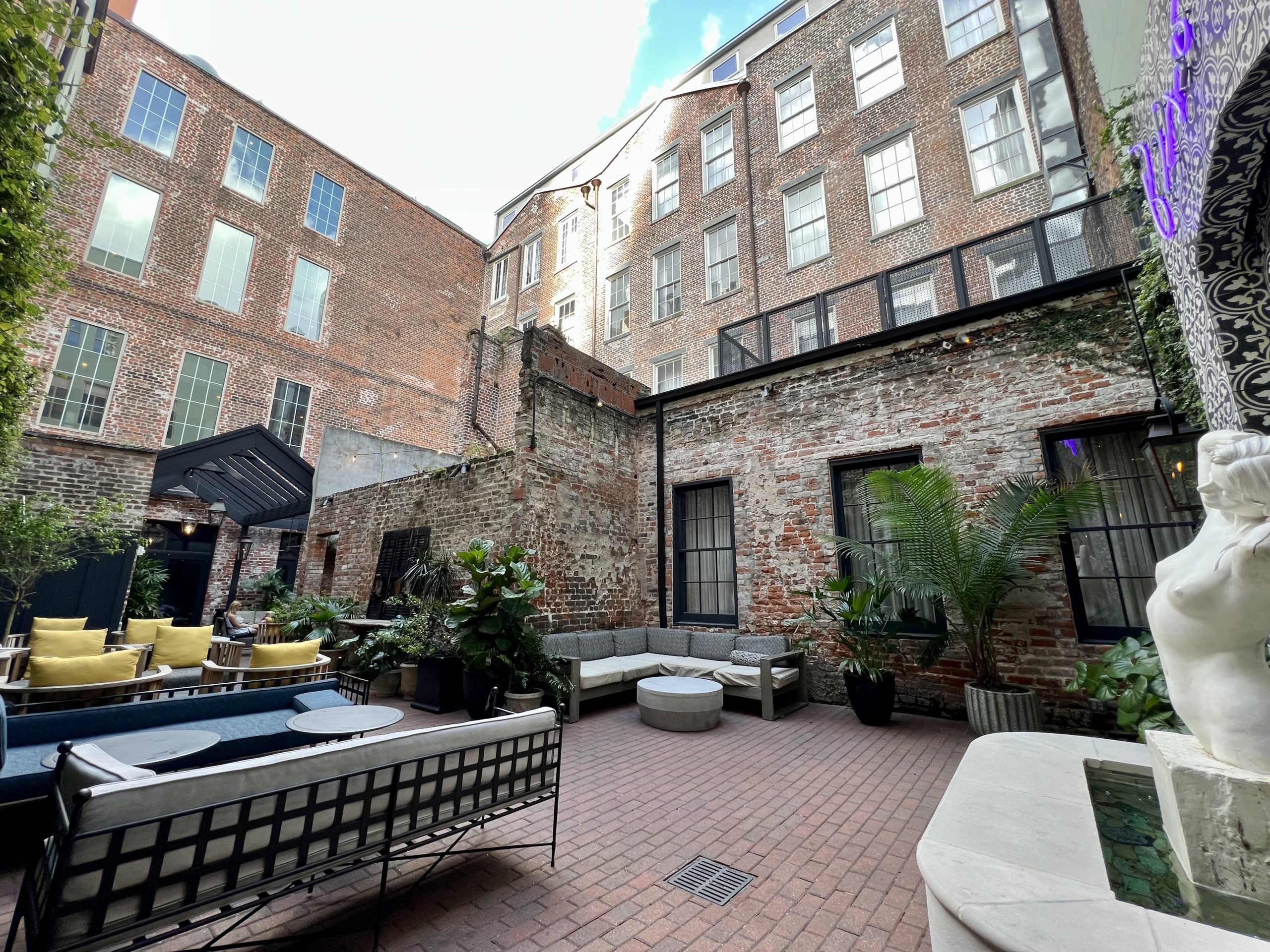 a courtyard with a brick building and a fountain