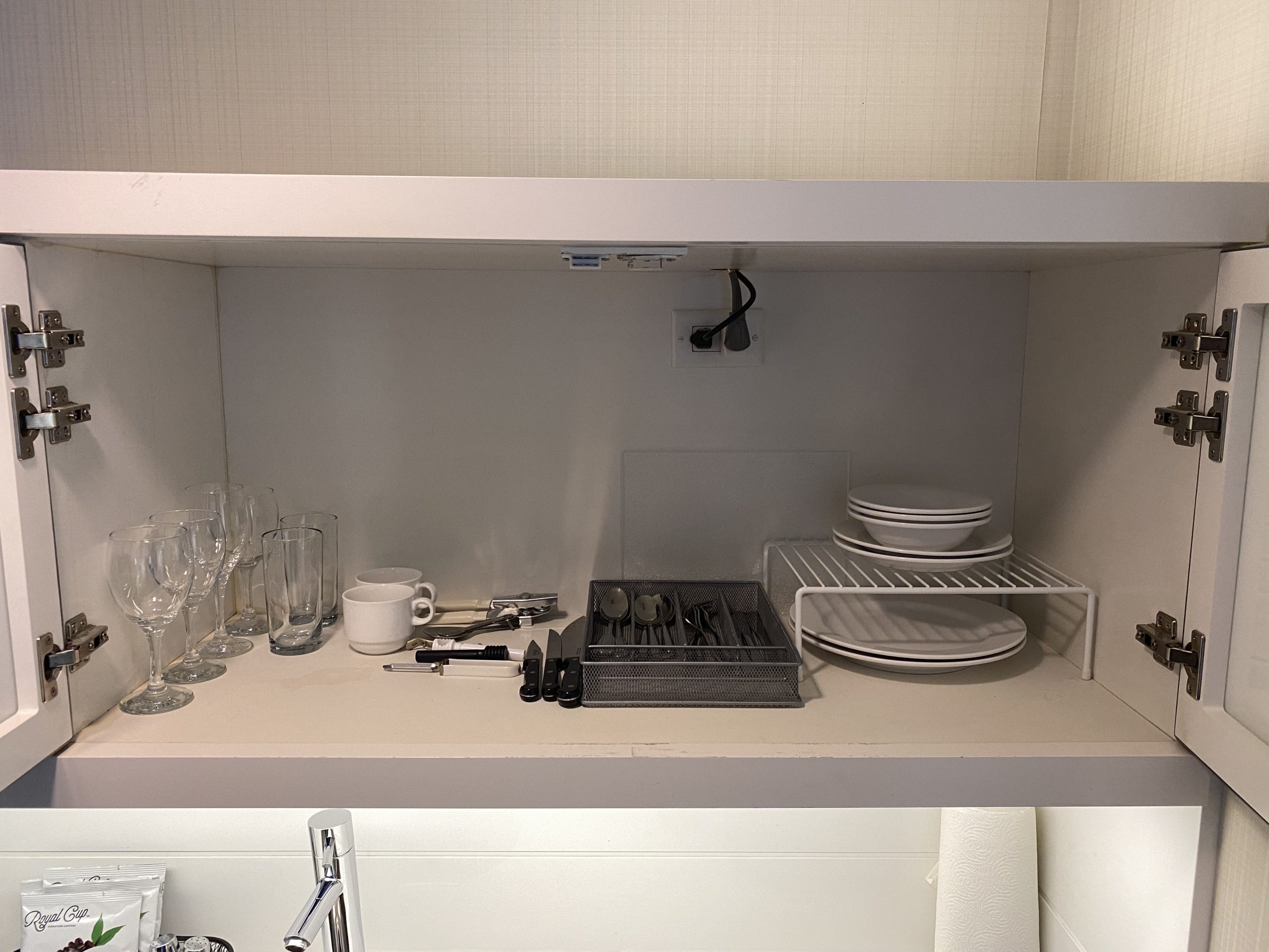 a shelf with dishes and glasses