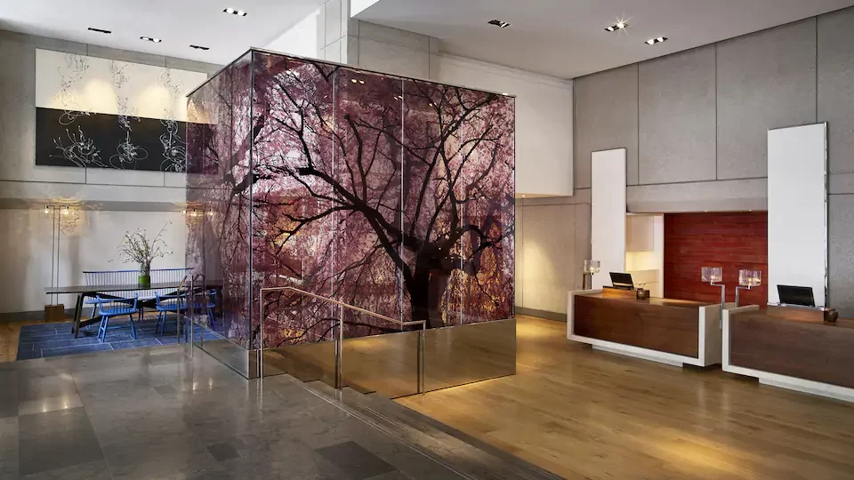 a glass wall with a tree on it