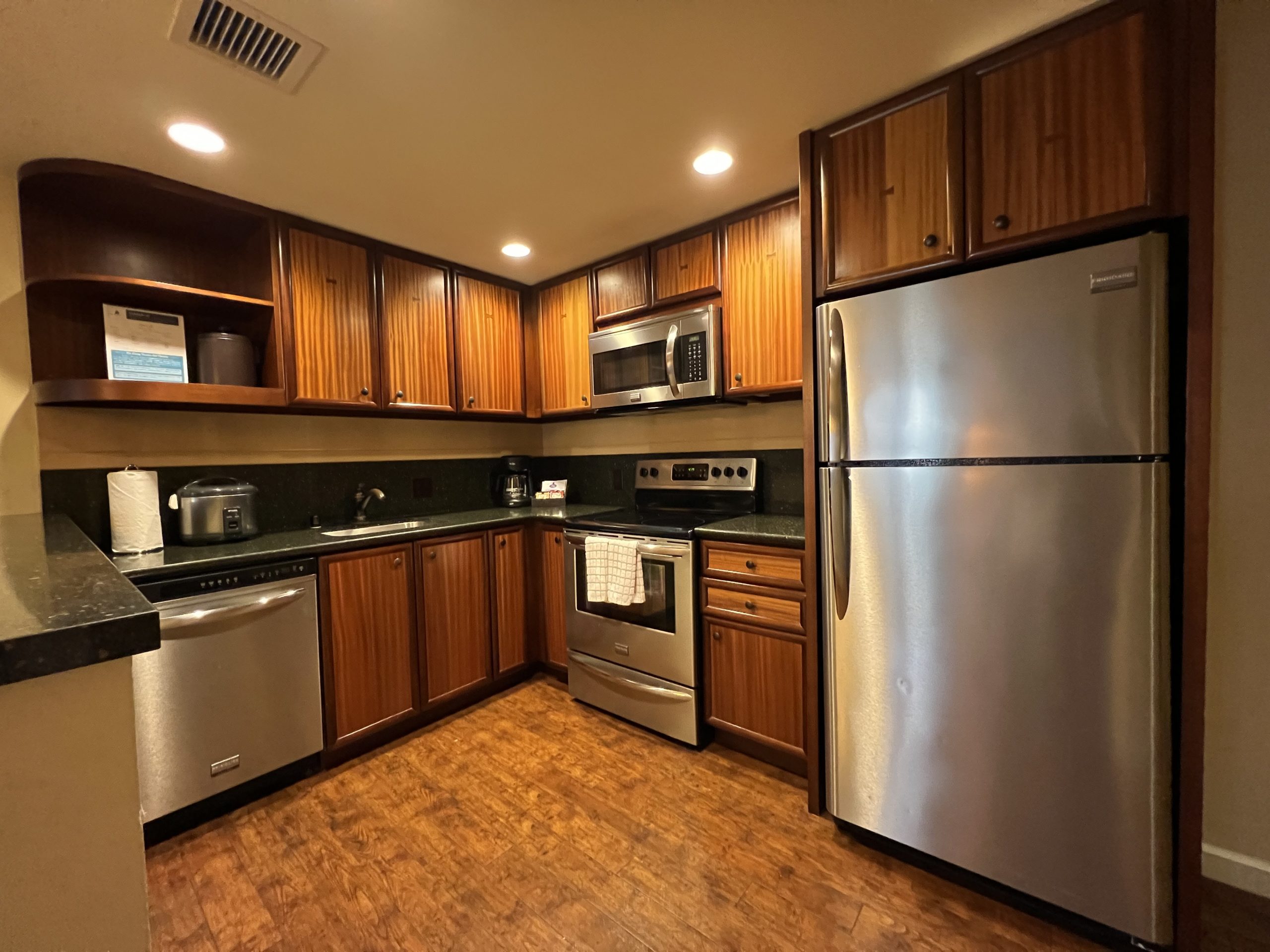 a kitchen with wood cabinets and stainless steel appliances