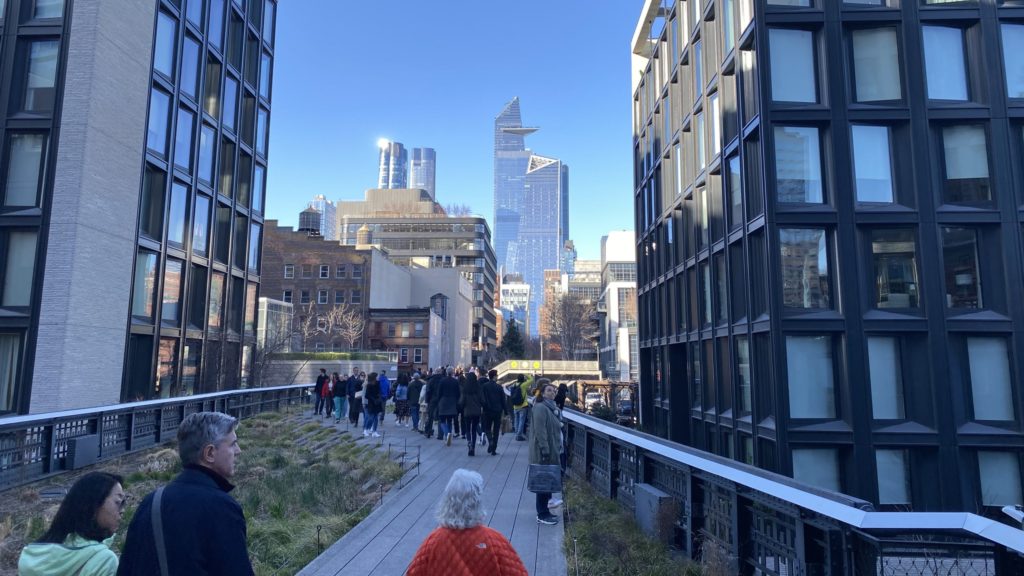 a group of people walking on a bridge