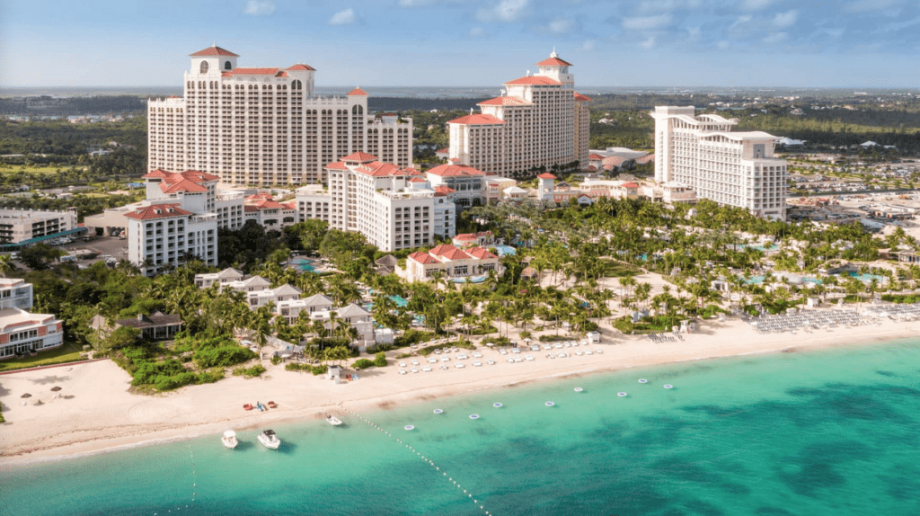 a beach with many white buildings and trees