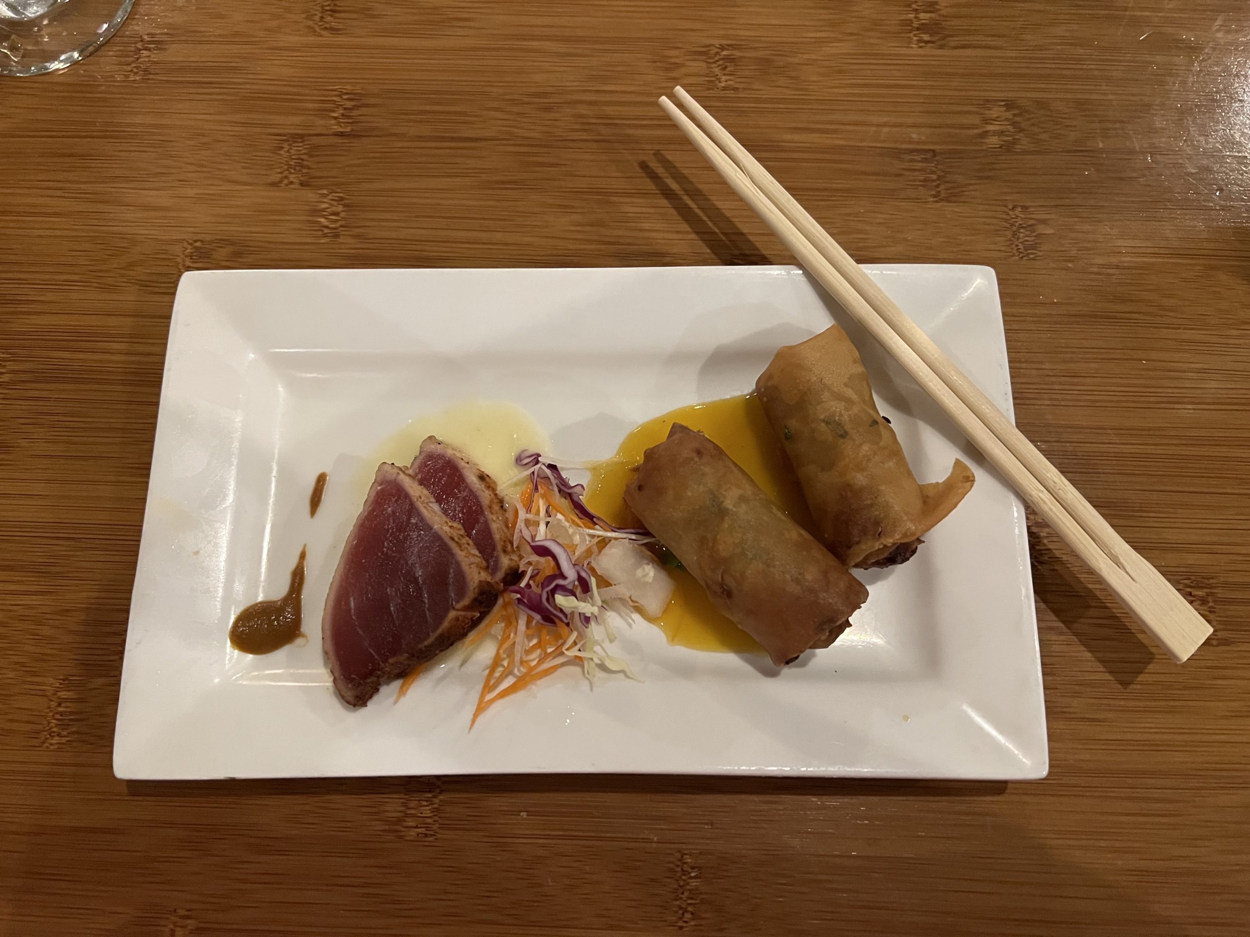 a plate of food with chopsticks