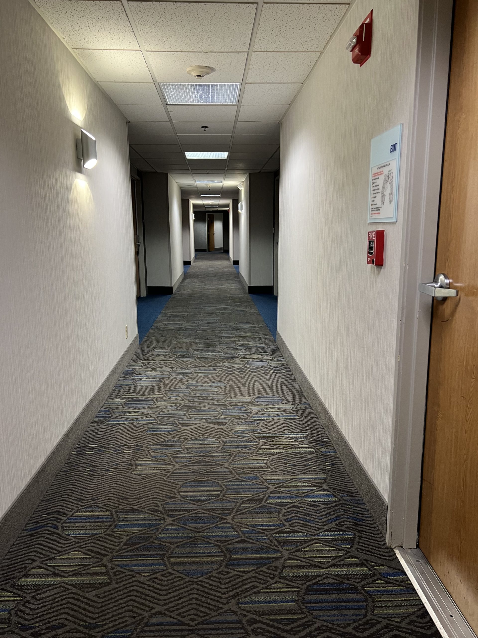 a hallway with a door and a sign