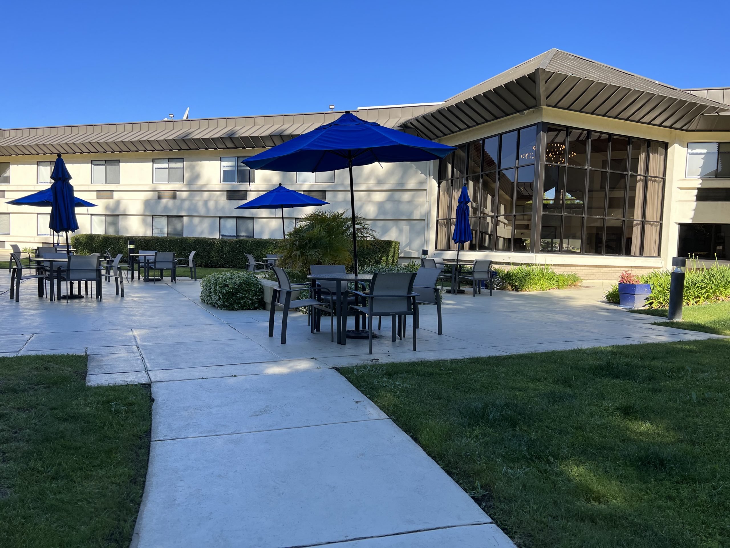 a patio with umbrellas and tables