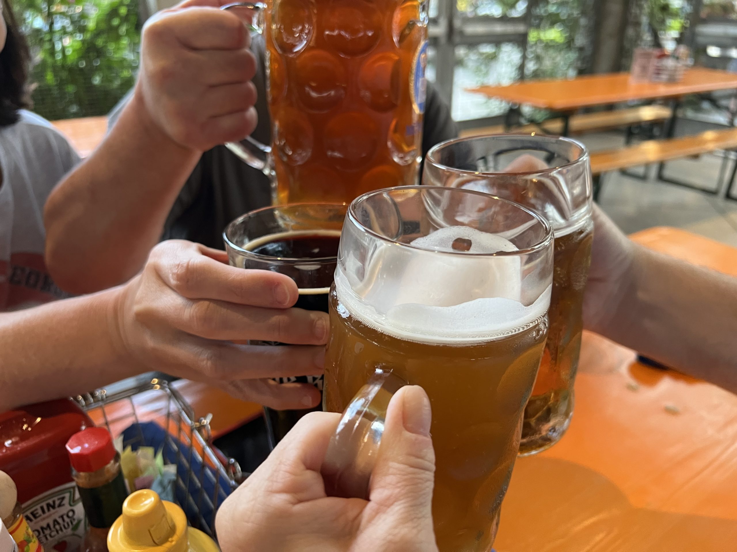 a group of people holding mugs of beer
