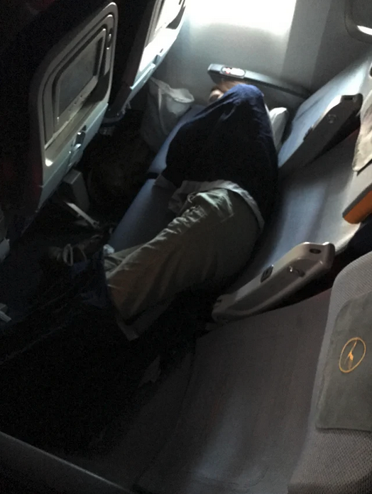 a person sleeping on a plane