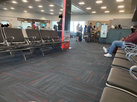 a person sitting on a chair in an airport
