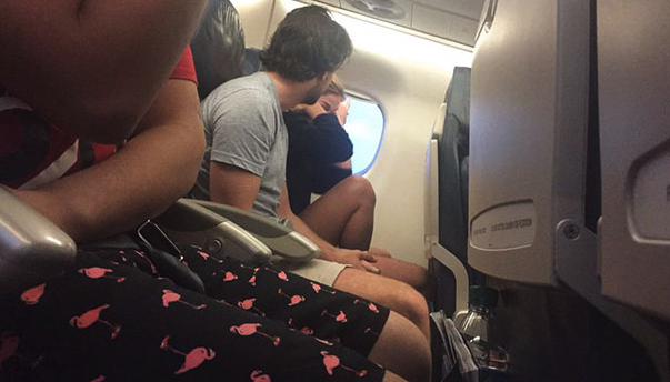 a couple of people sitting on an airplane
