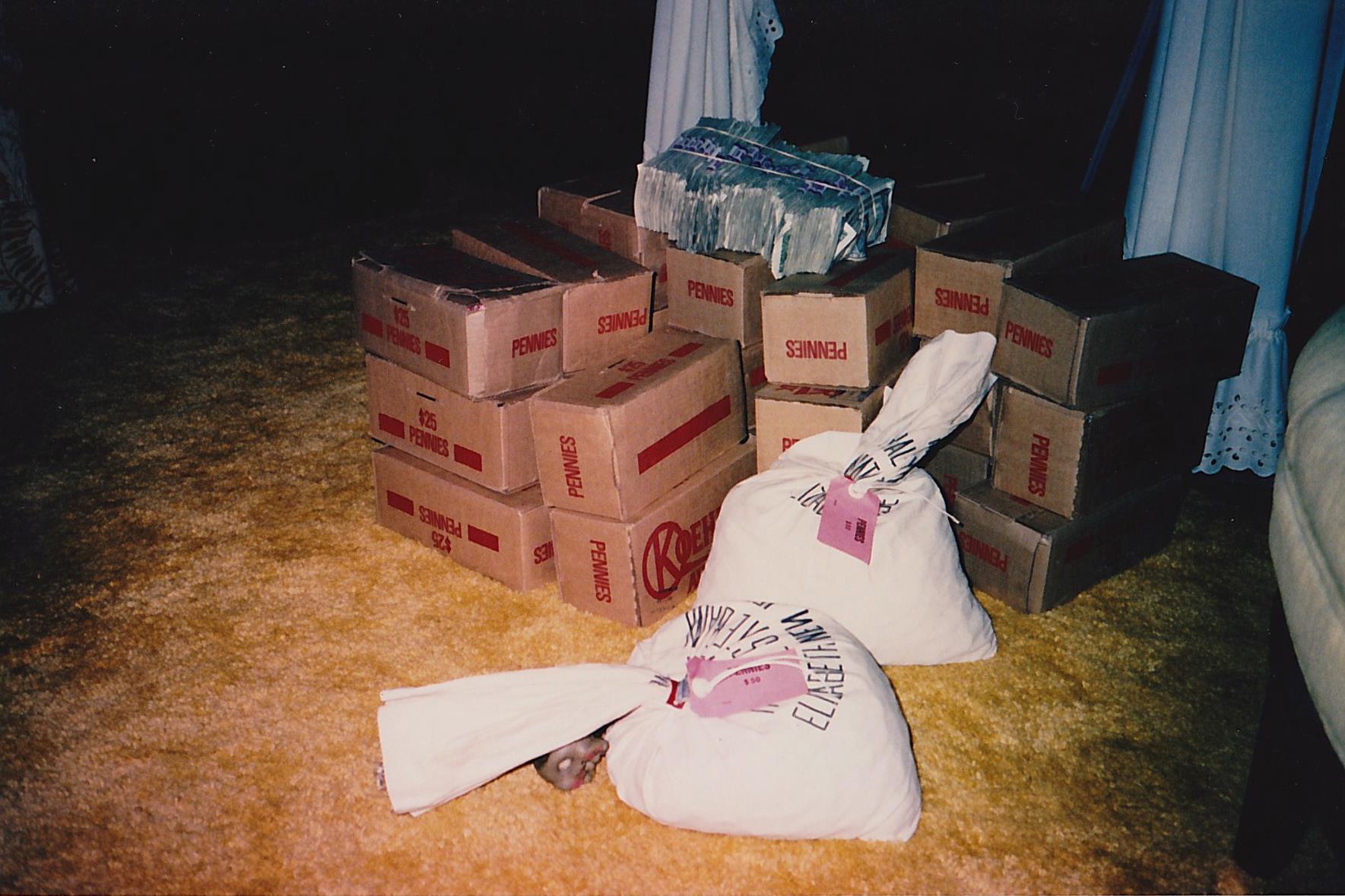 a pile of boxes with a person lying on the floor