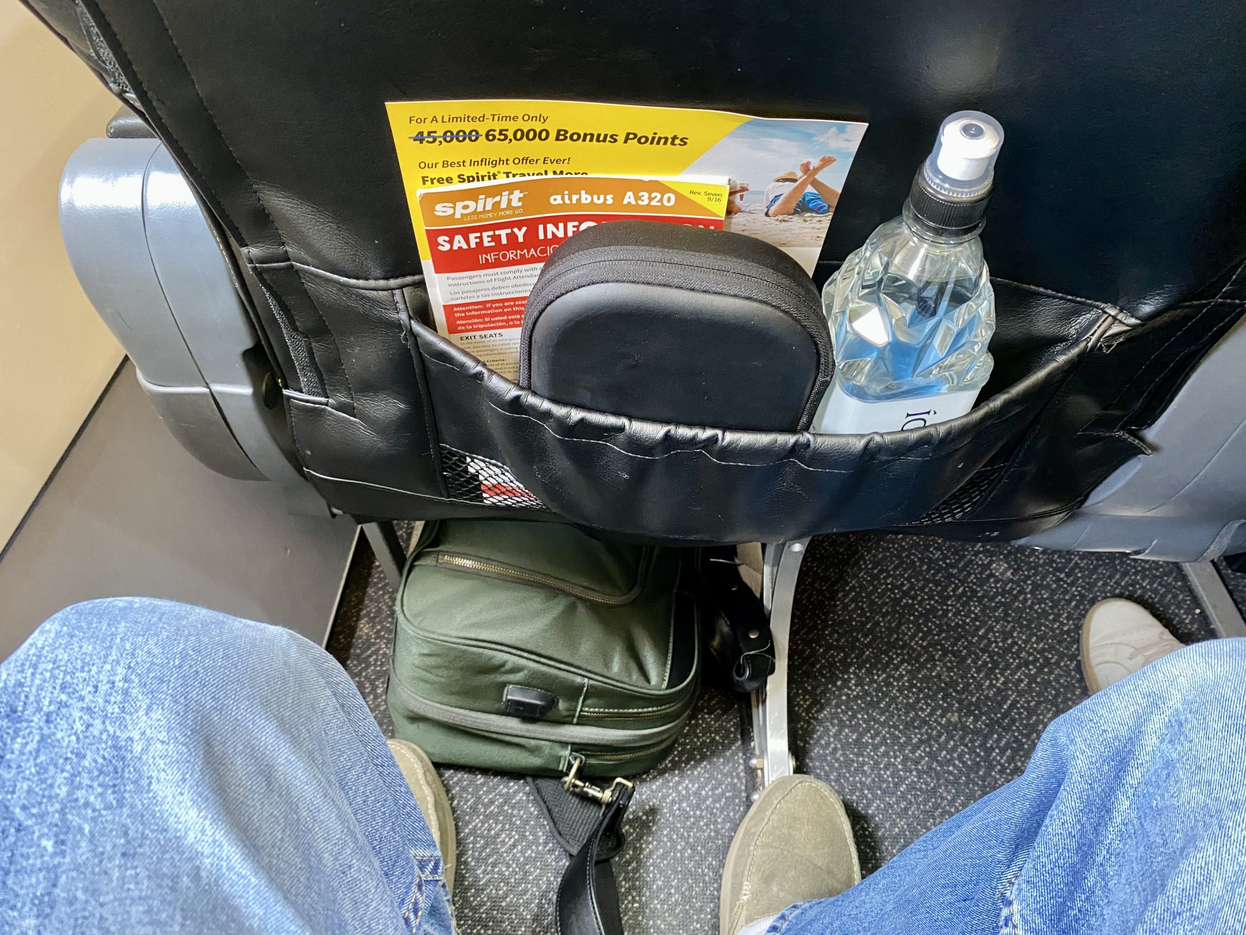 a seat with a bag and a bottle of water in it