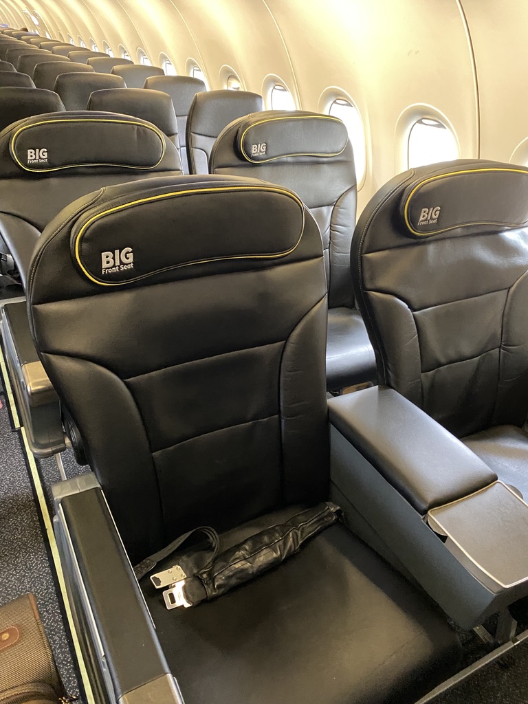 a row of black seats on an airplane